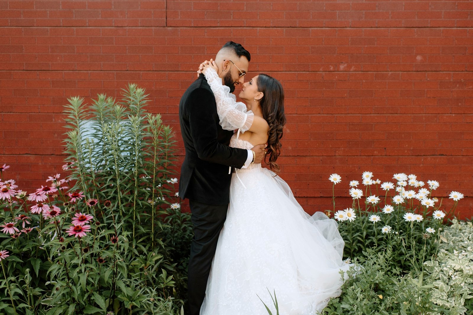 wedding-bliss-against-a-brick-wall-backdrop.jpg